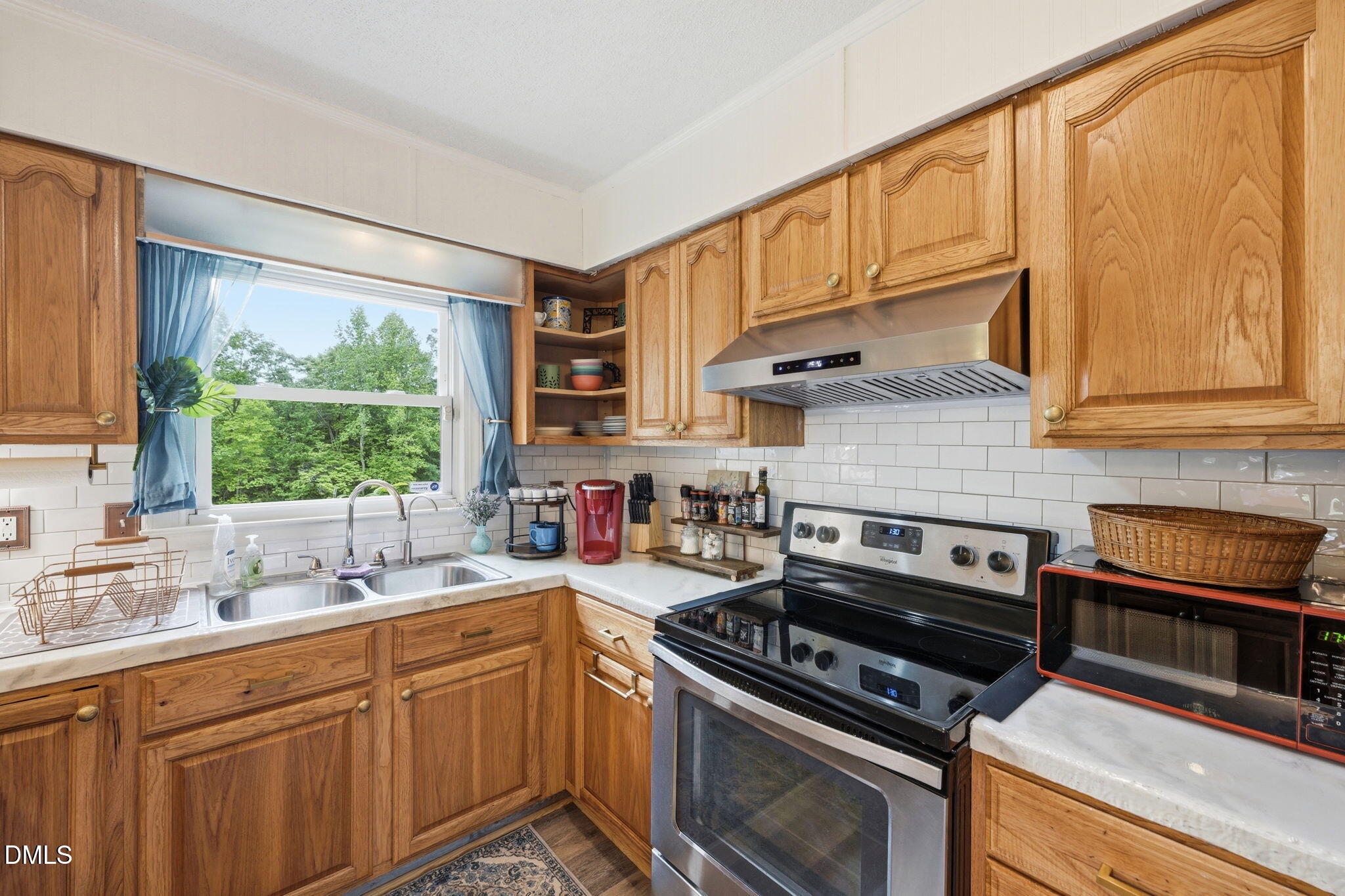 3200 Mill Creek Road Efland, NC 27243 - Photo 25 of 44 a kitchen with stainless steel appliances a stove sink and cabinets