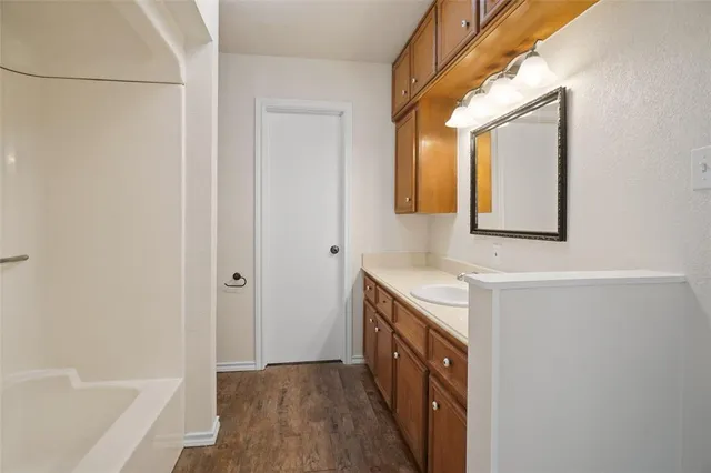 a bathroom with a sink a mirror and a bathtub
