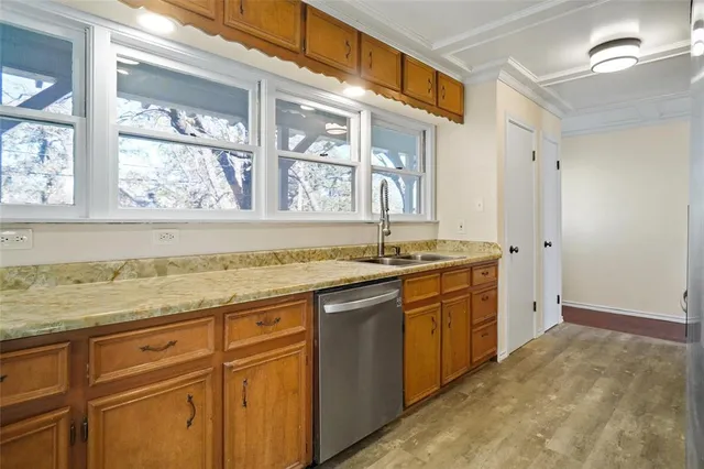 a view of a granite countertop sink and a window