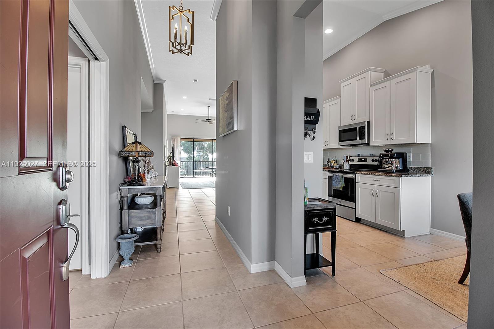 13608 Messina Loop, Unit 201 Bradenton, FL 34211 - Photo 11 of 68 a kitchen with a refrigerator and a stove top oven