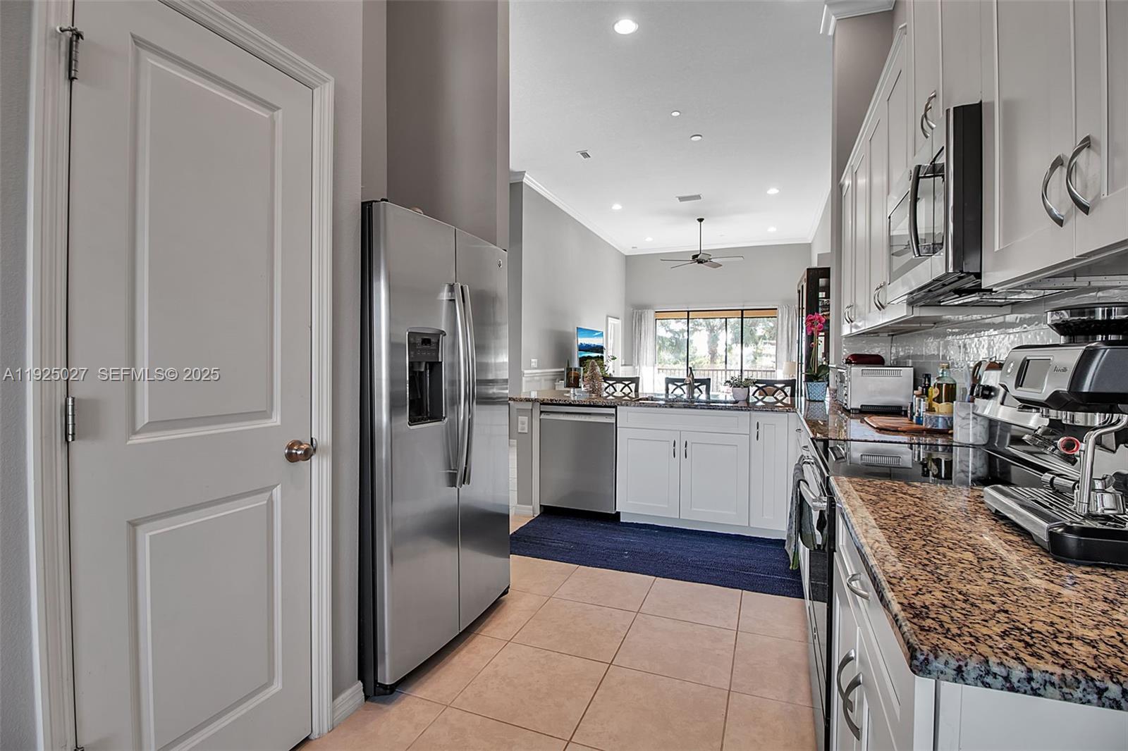 13608 Messina Loop, Unit 201 Bradenton, FL 34211 - Photo 14 of 68 a kitchen with stainless steel appliances granite countertop a refrigerator and a sink