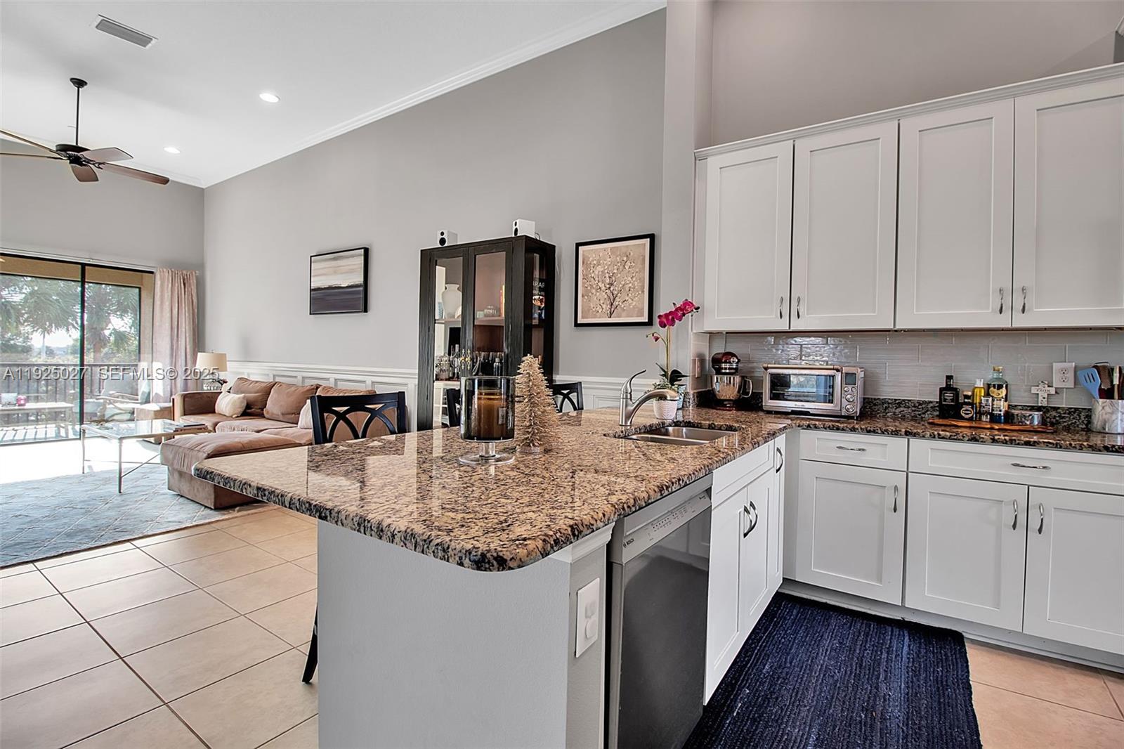 13608 Messina Loop, Unit 201 Bradenton, FL 34211 - Photo 17 of 68 a kitchen with sink cabinets and wooden floor