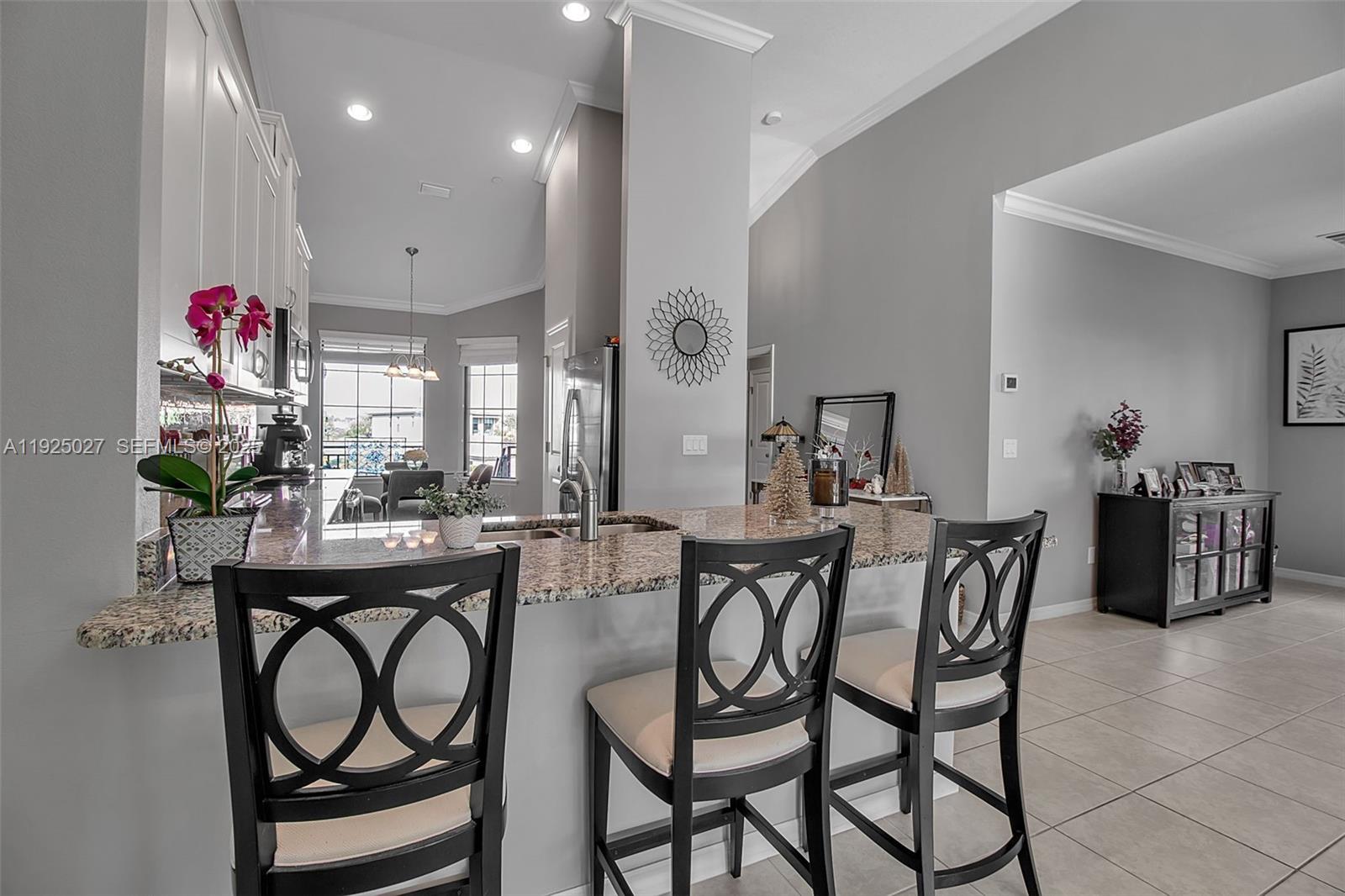 13608 Messina Loop, Unit 201 Bradenton, FL 34211 - Photo 19 of 68 a view of a dining room with furniture and chandelier