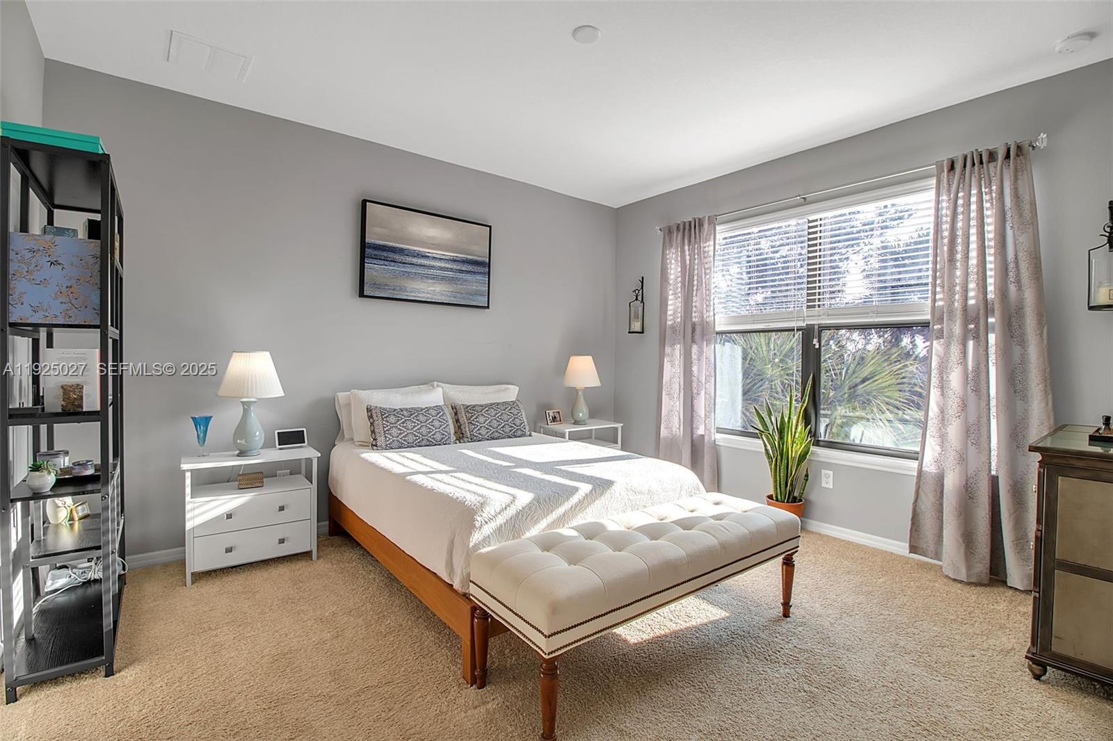 13608 Messina Loop, Unit 201 Bradenton, FL 34211 - Photo 32 of 68 a bedroom with a bed lamp and a large window