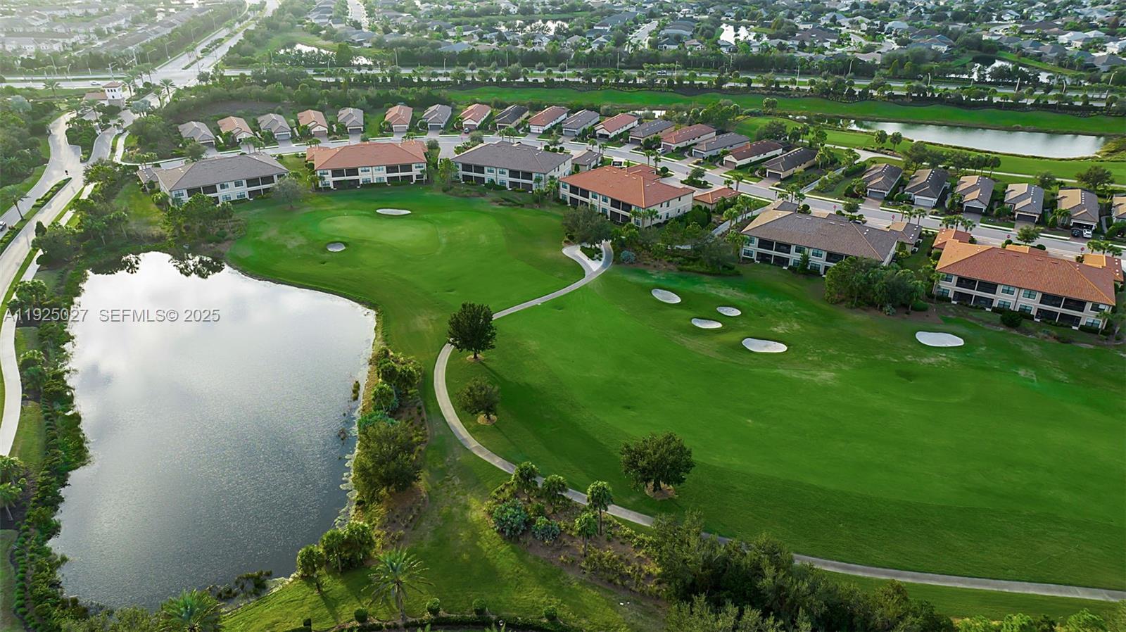 13608 Messina Loop, Unit 201 Bradenton, FL 34211 - Photo 42 of 68 a view of a golf course with parking space