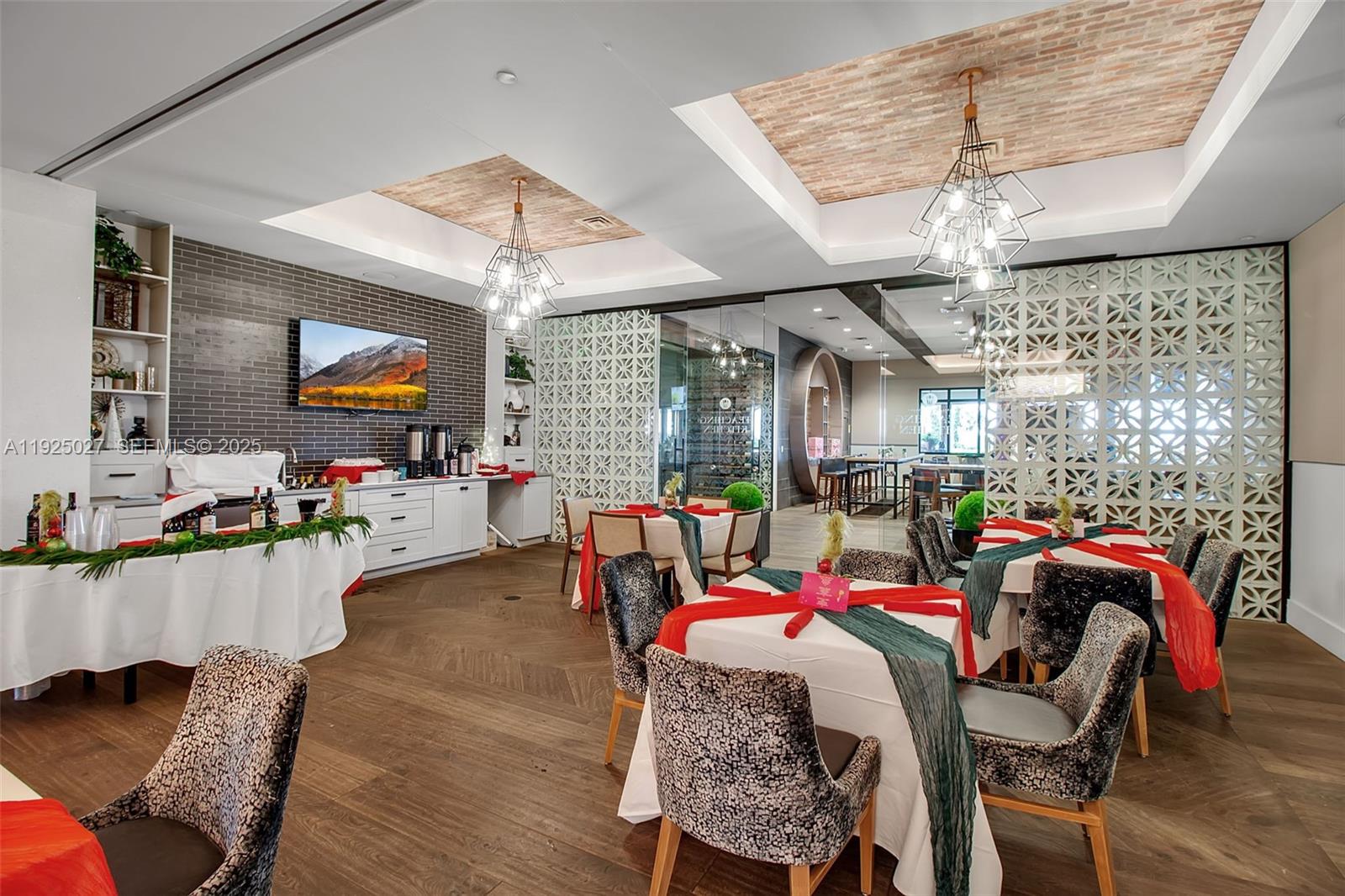 13608 Messina Loop, Unit 201 Bradenton, FL 34211 - Photo 60 of 68 a living room with furniture a flat screen tv and floor to ceiling window