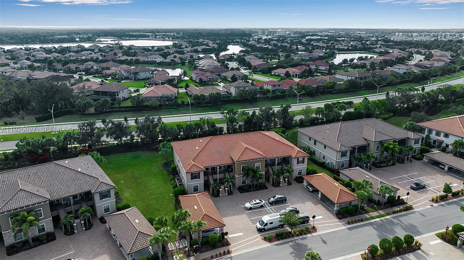 13608 Messina Loop, Unit 201 Bradenton, FL 34211 - Photo 9 of 68 an aerial view of a house with a garden and lake view