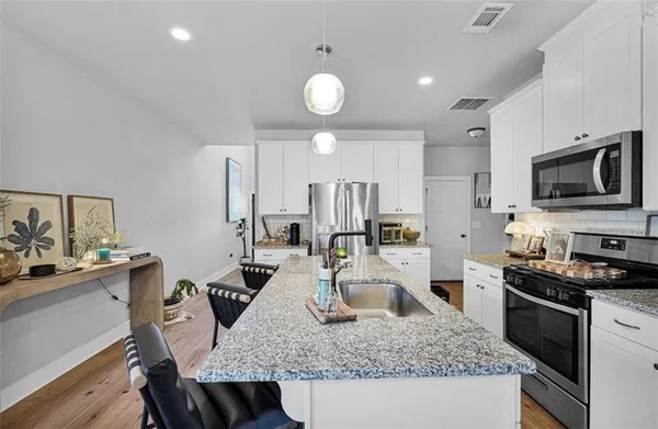 a living room with furniture and flat screen tv