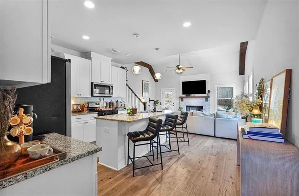 a kitchen with stainless steel appliances kitchen island granite countertop a stove and a sink with granite countertops