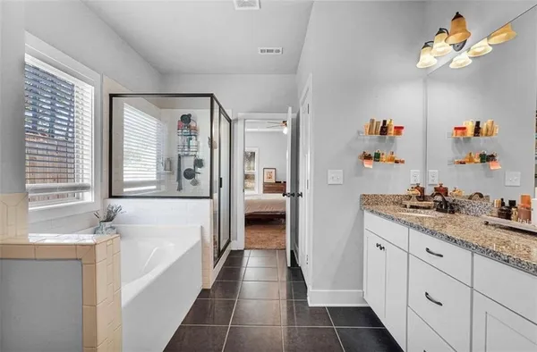 a view of a bathroom with a glass door shower