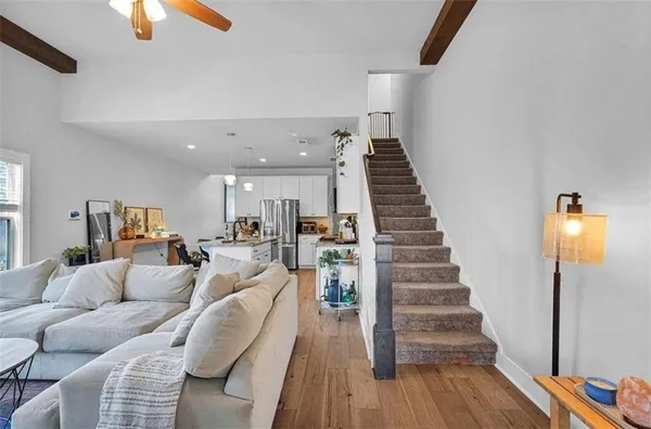 a living room with furniture a fireplace and a flat screen tv