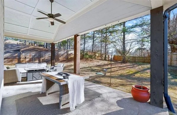a view of a house with backyard porch and sitting area