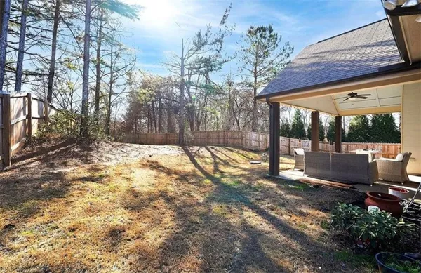 a view of yard with wooden fence