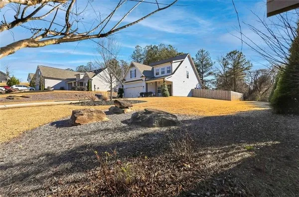 a view of a pathway of a house with a large tree