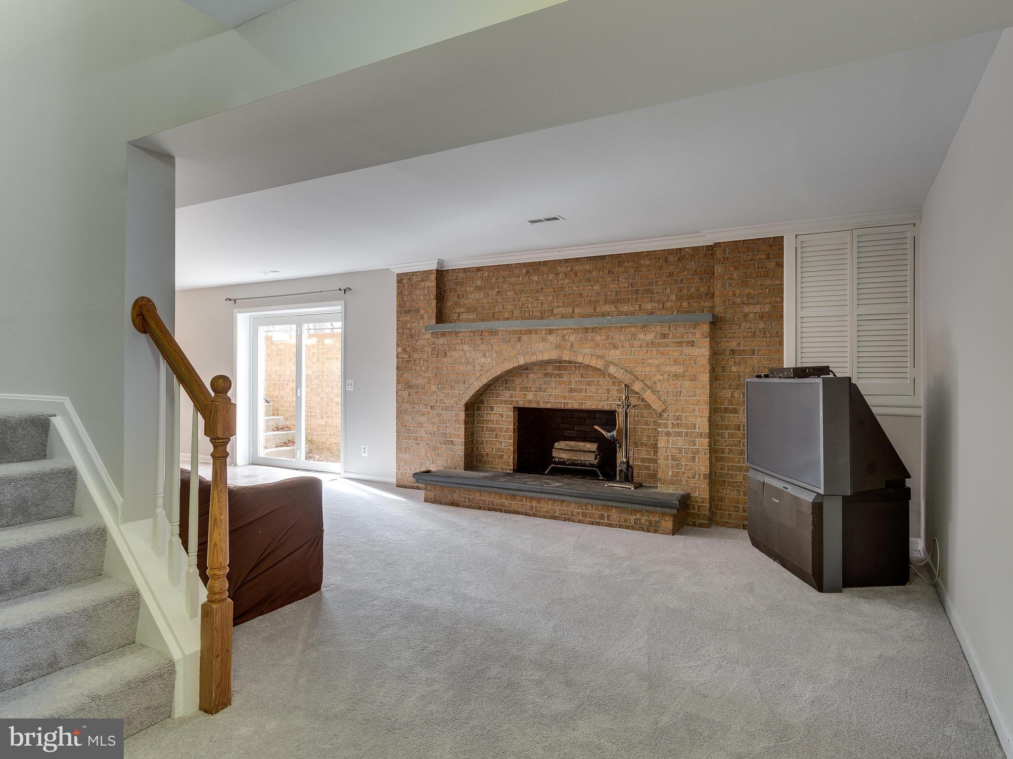 5613 Clifton Road Clifton, VA 20124 - Photo 30 of 42 Exposed brick fireplace in basement.