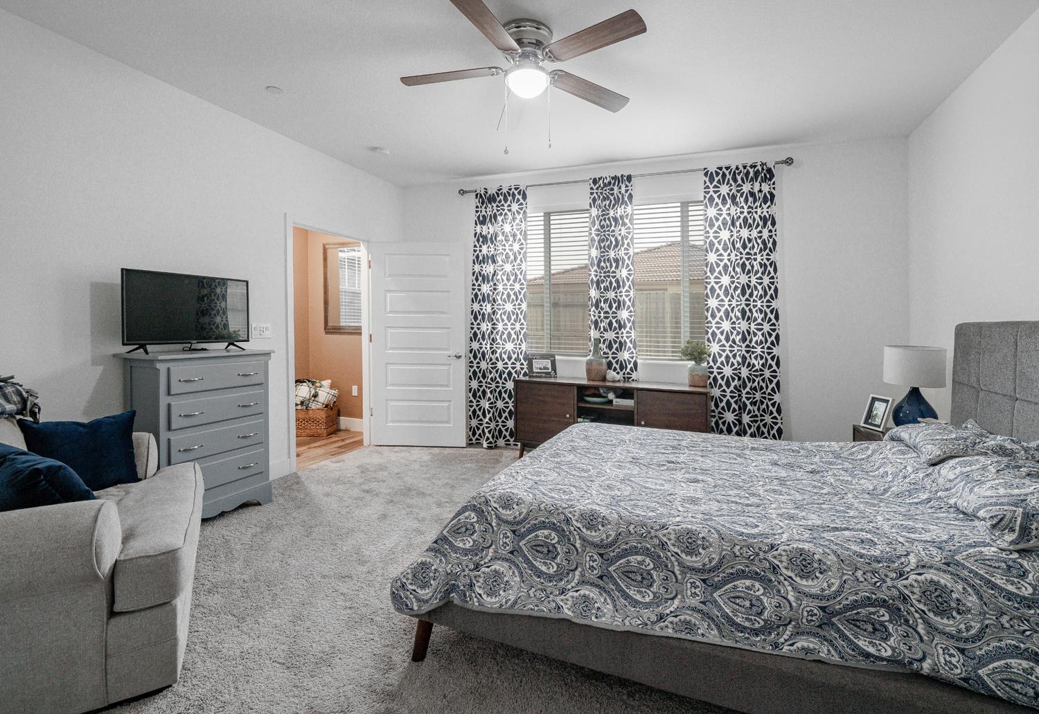 4414 Hawkfinch Circle Rancho Cordova, CA 95742 - Photo 3 of 40 a bedroom with a bed and a flat screen tv