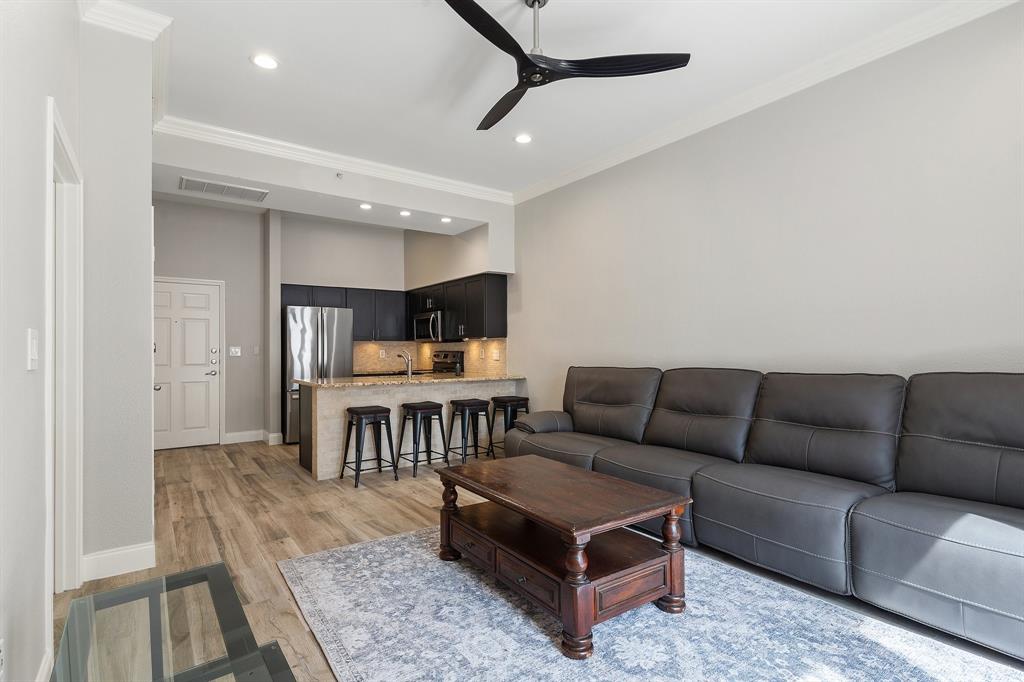 3102 Kings Road, Unit 1106 Dallas, TX 75219 - Photo 9 of 20 a living room with furniture and a table