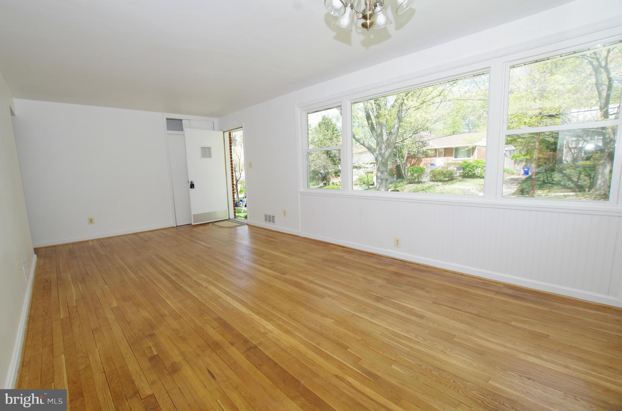 12712 Helen Road Silver Spring, MD 20906 - Photo 8 of 30 a view of an empty room with wooden floor and a window