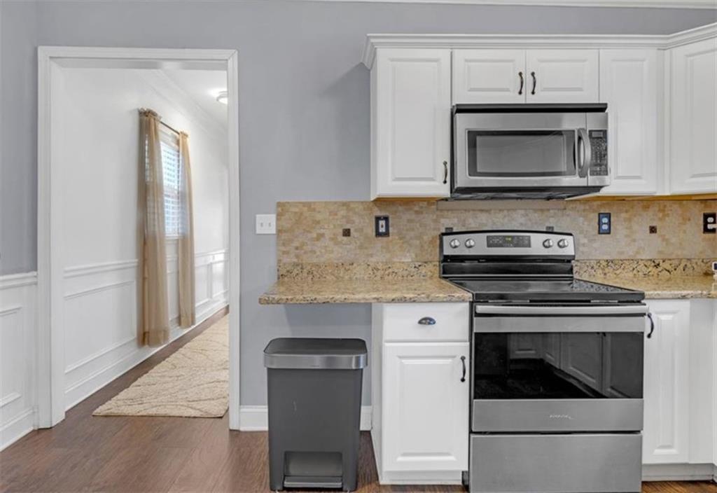 1146 Sims Street Southwest Atlanta, GA 30310 - Photo 11 of 20 a kitchen with granite countertop a stove and a microwave