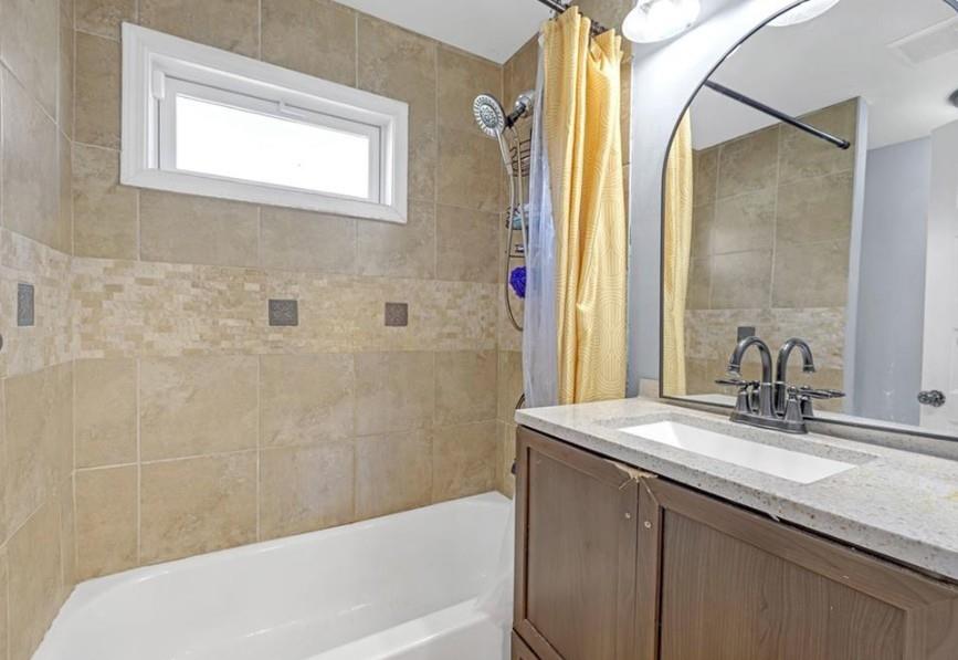 1146 Sims Street Southwest Atlanta, GA 30310 - Photo 16 of 20 a bathroom with a granite countertop sink a mirror and a bathtub