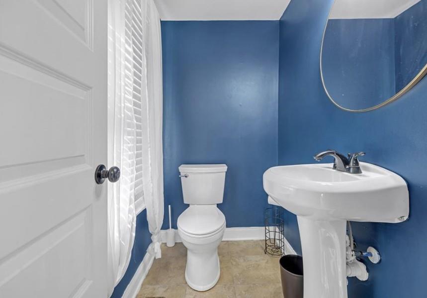 1146 Sims Street Southwest Atlanta, GA 30310 - Photo 17 of 20 a bathroom with a toilet sink and mirror