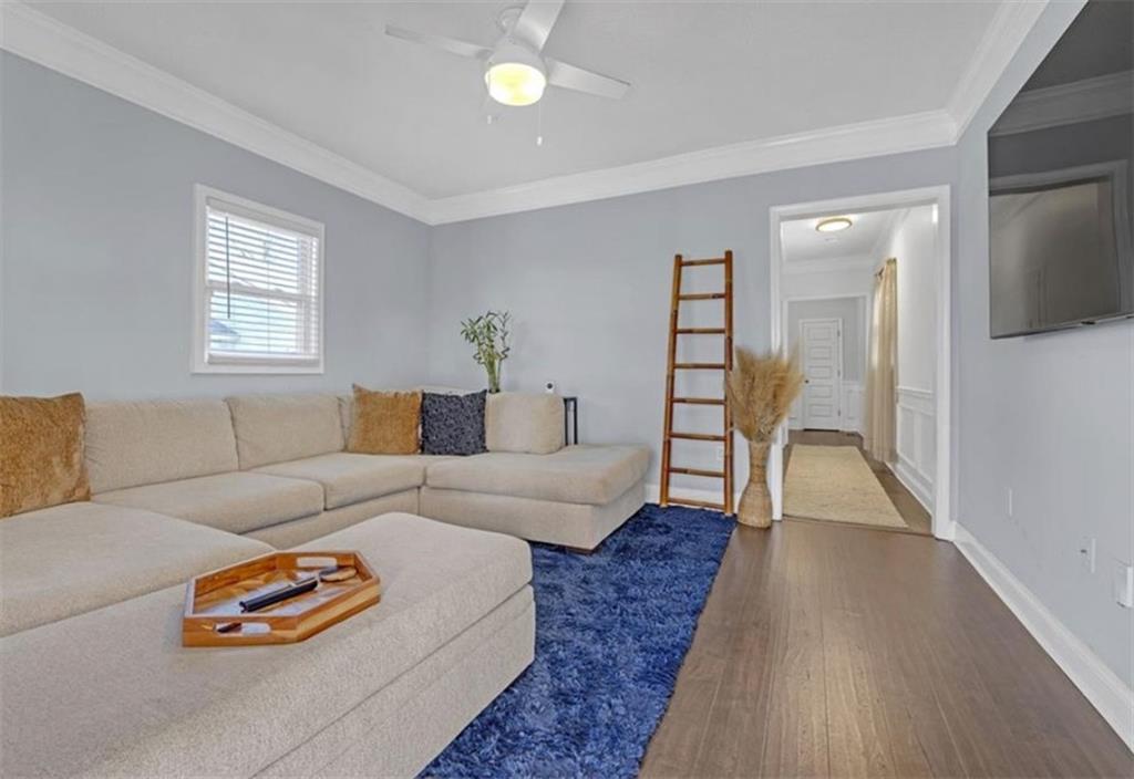 1146 Sims Street Southwest Atlanta, GA 30310 - Photo 7 of 20 a living room with furniture and a wooden floor