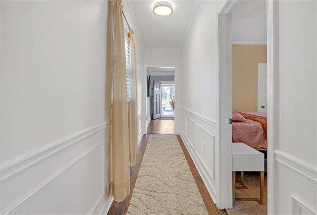 1146 Sims Street Southwest Atlanta, GA 30310 - Photo 8 of 20 a view of a hallway with a white walls and a bathroom