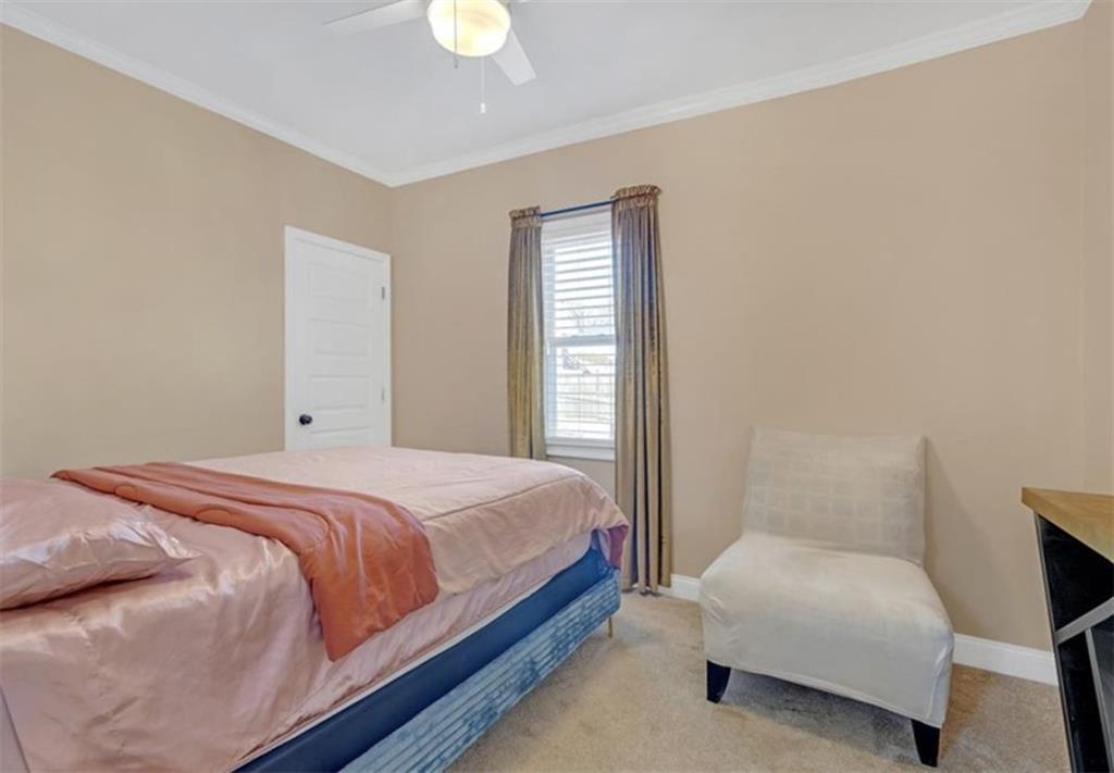 1146 Sims Street Southwest Atlanta, GA 30310 - Photo 9 of 20 a bedroom with a bed lamp and a window