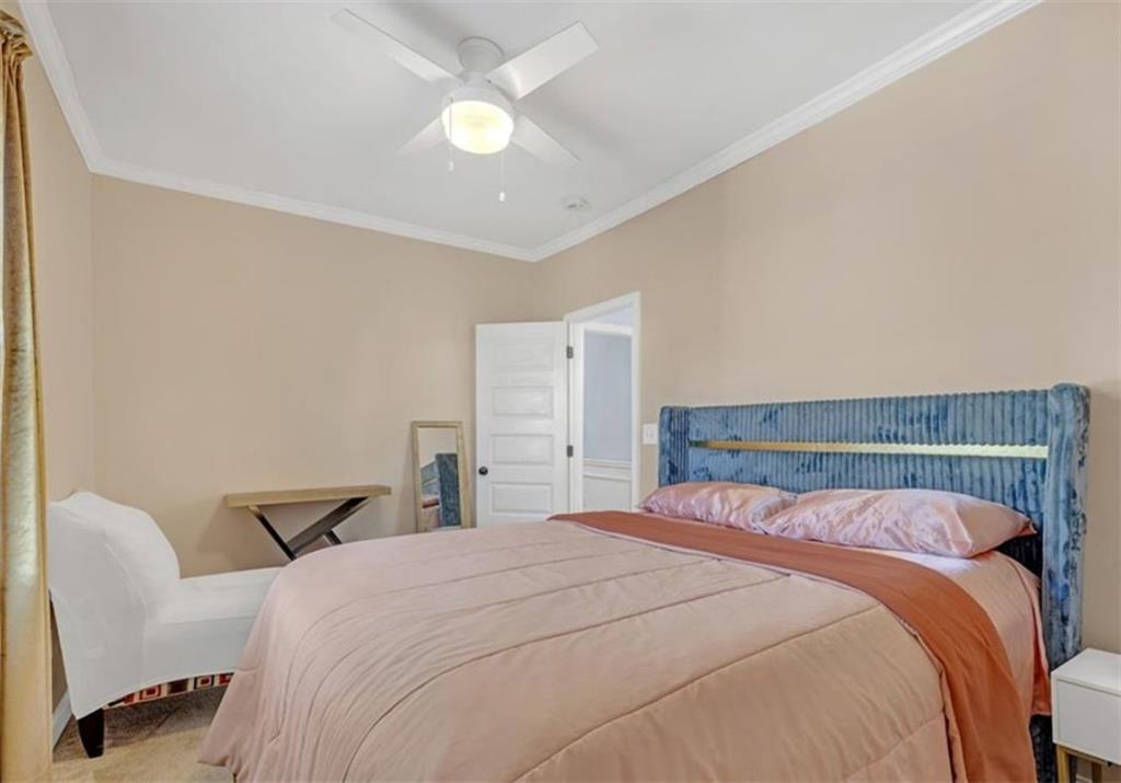 1146 Sims Street Southwest Atlanta, GA 30310 - Photo 10 of 20 a bedroom with a bed and a chandelier