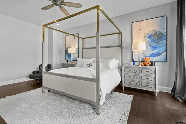 a bedroom with a bed and a painting on the wall