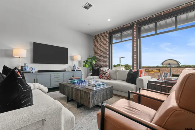 a living room with furniture and a flat screen tv