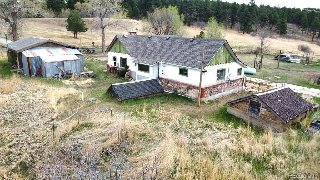 8180 Old San Isabel Road Rye, CO 81069 - Photo 3 of 35 a aerial view of a house with table and chairs under an umbrella