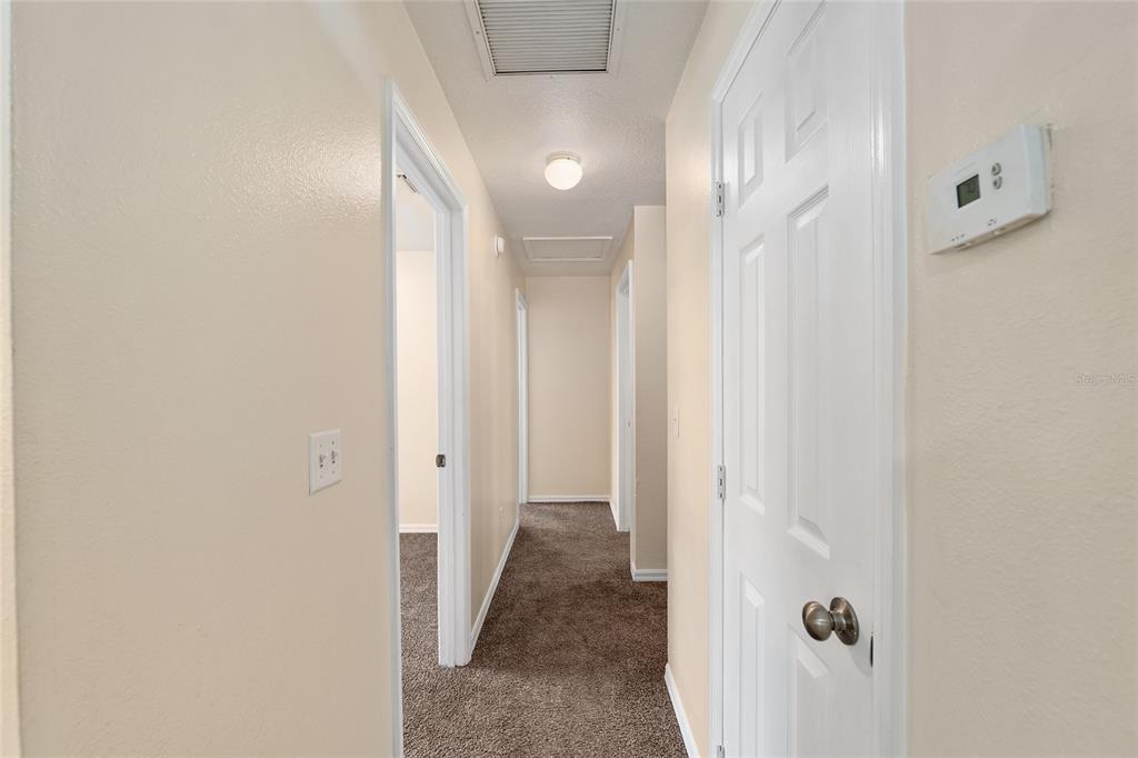 4329 Northwest 155th Street Reddick, FL 32686 - Photo 28 of 52 a view of a hallway with wooden floor and a bathroom