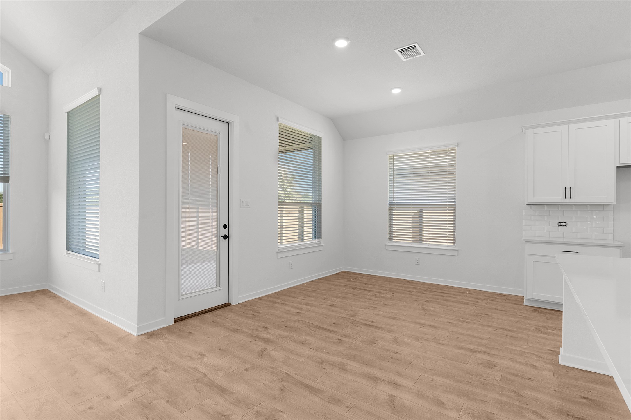 328 Ridgewell Loop Georgetown, TX 78633 - Photo 14 of 28 Unfurnished dining area featuring light wood finished floors, recessed lighting, and vaulted ceiling
