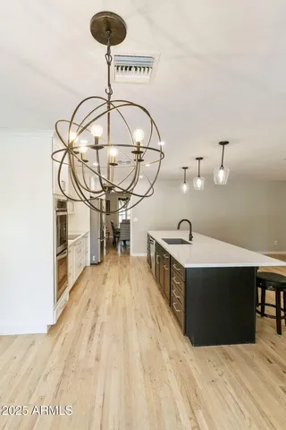 a kitchen with stainless steel appliances kitchen island granite countertop a sink and cabinets