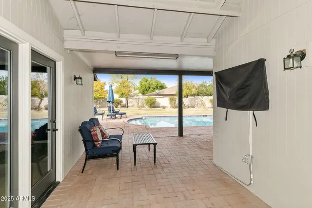 a view of a house with pool and a yard