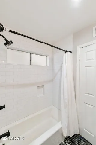 a bedroom with a bed and a tv