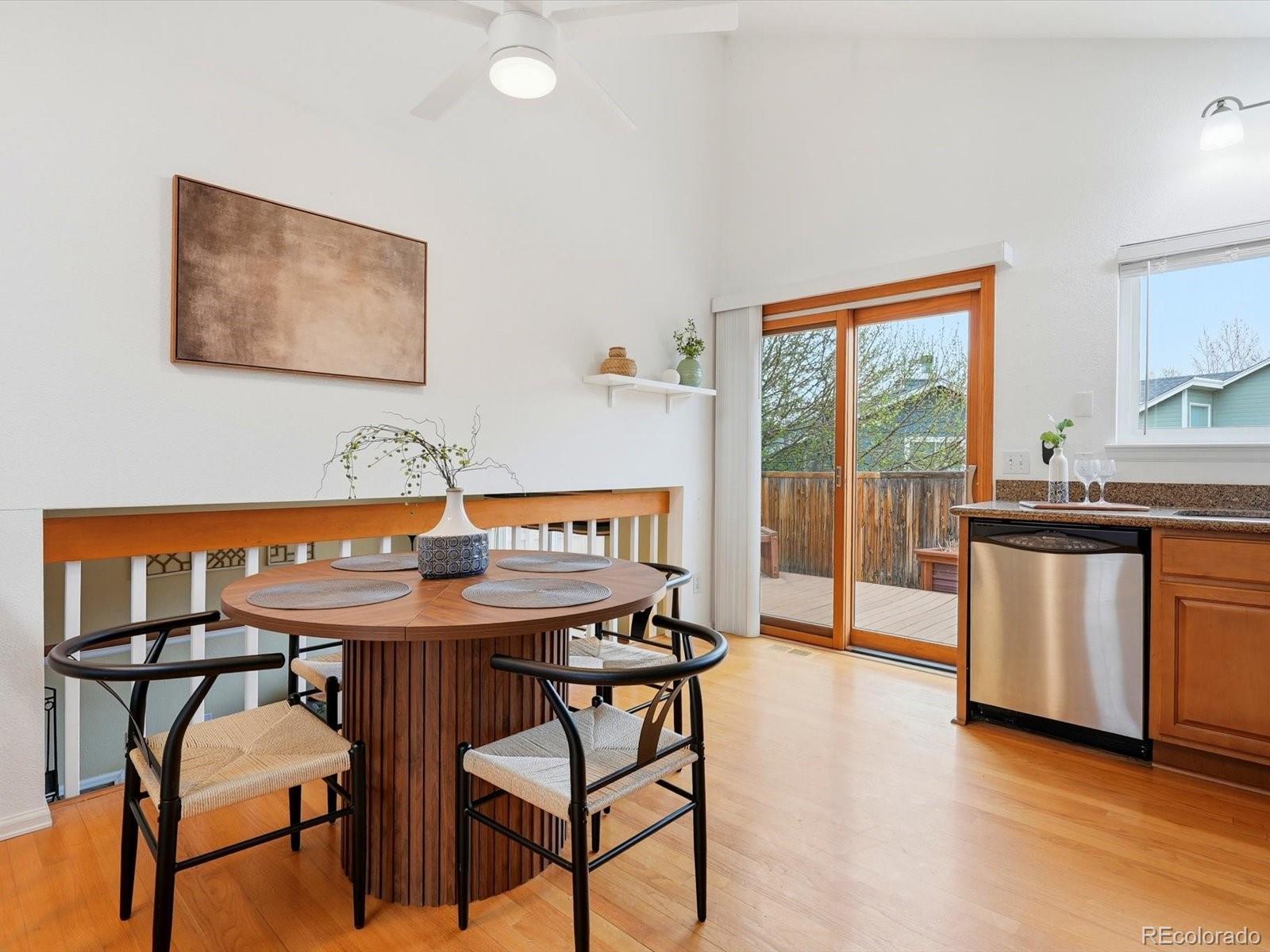 765 Stowe Street Highlands Ranch, CO 80126 - Photo 13 of 43 a dining room with a wooden table and chairs