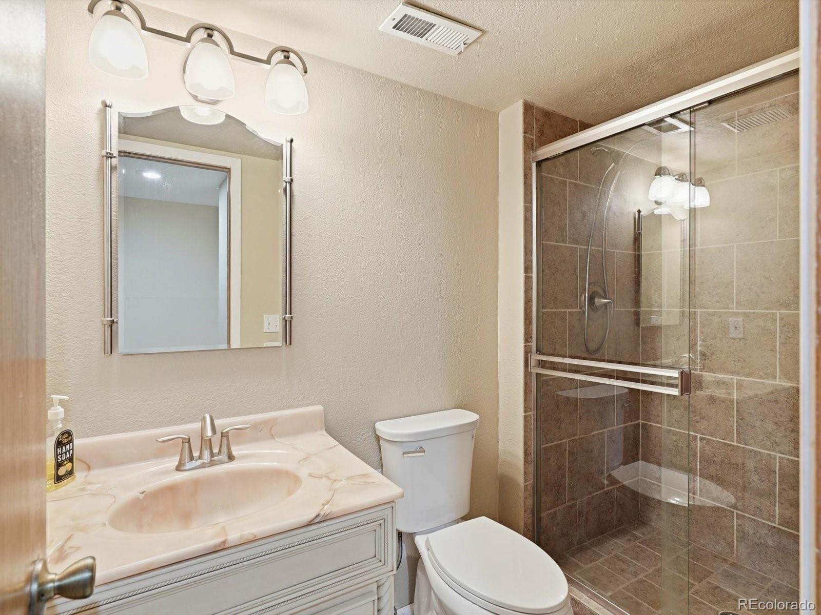 765 Stowe Street Highlands Ranch, CO 80126 - Photo 21 of 43 a bathroom with a sink a toilet and shower