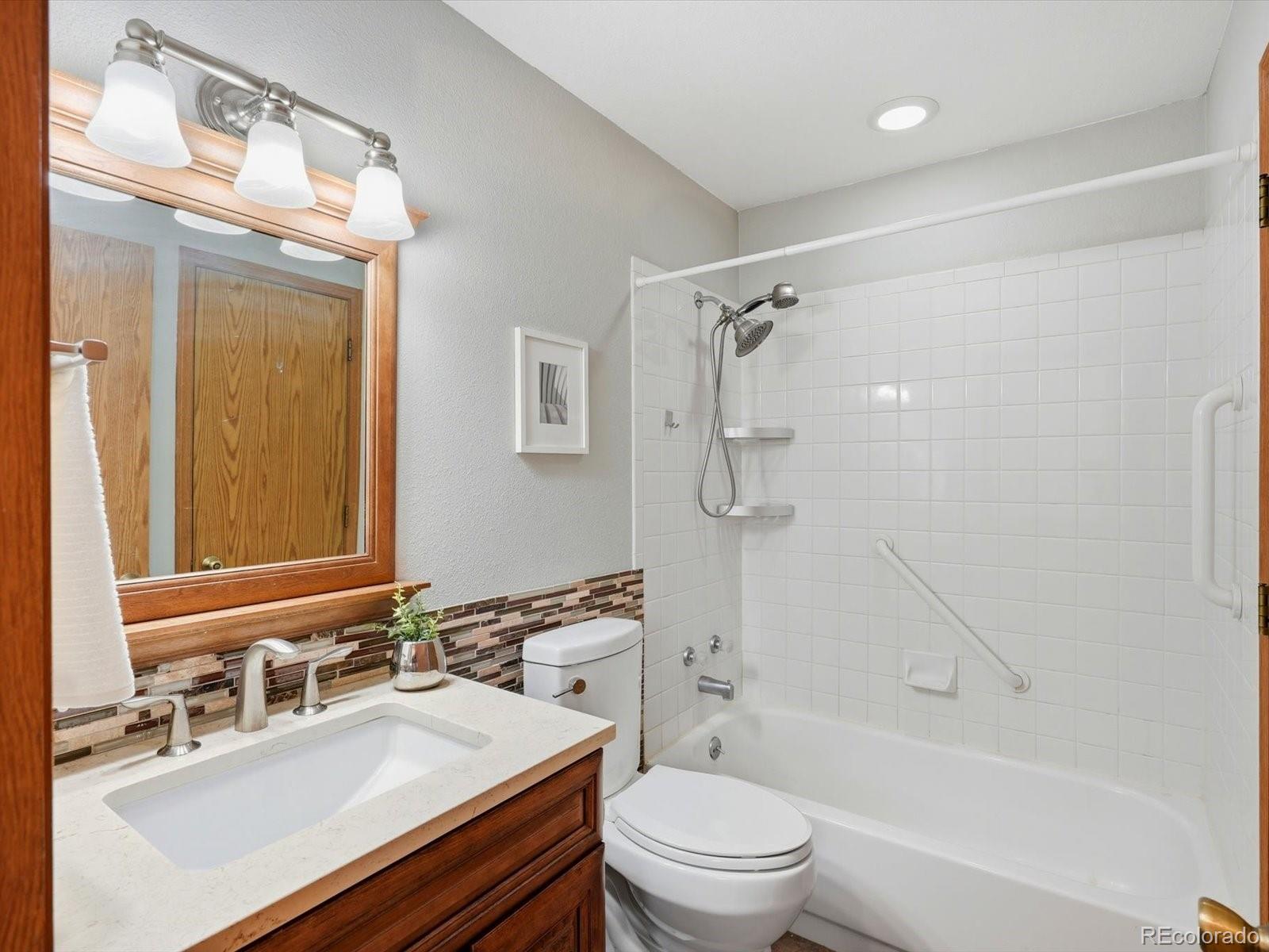 765 Stowe Street Highlands Ranch, CO 80126 - Photo 28 of 43 a bathroom with a sink toilet tub vanity and shower