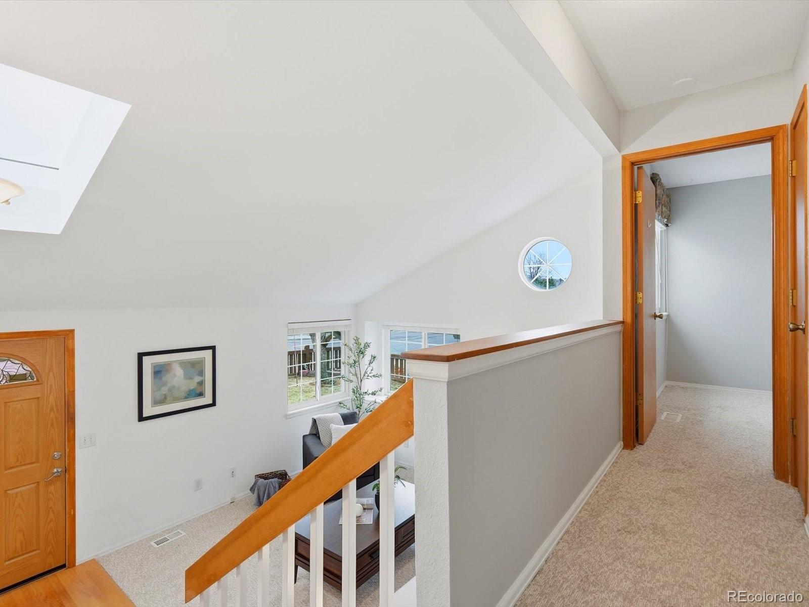 765 Stowe Street Highlands Ranch, CO 80126 - Photo 31 of 43 a view of a hallway with workspace