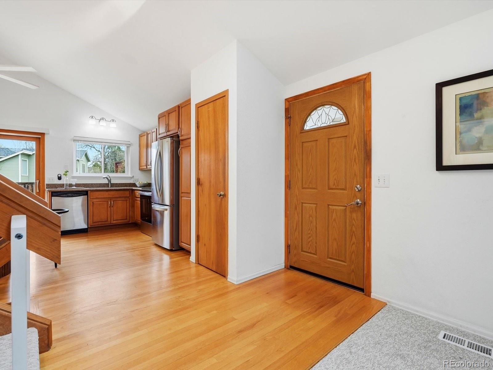 765 Stowe Street Highlands Ranch, CO 80126 - Photo 4 of 43 a view of a kitchen with furniture and an entryway
