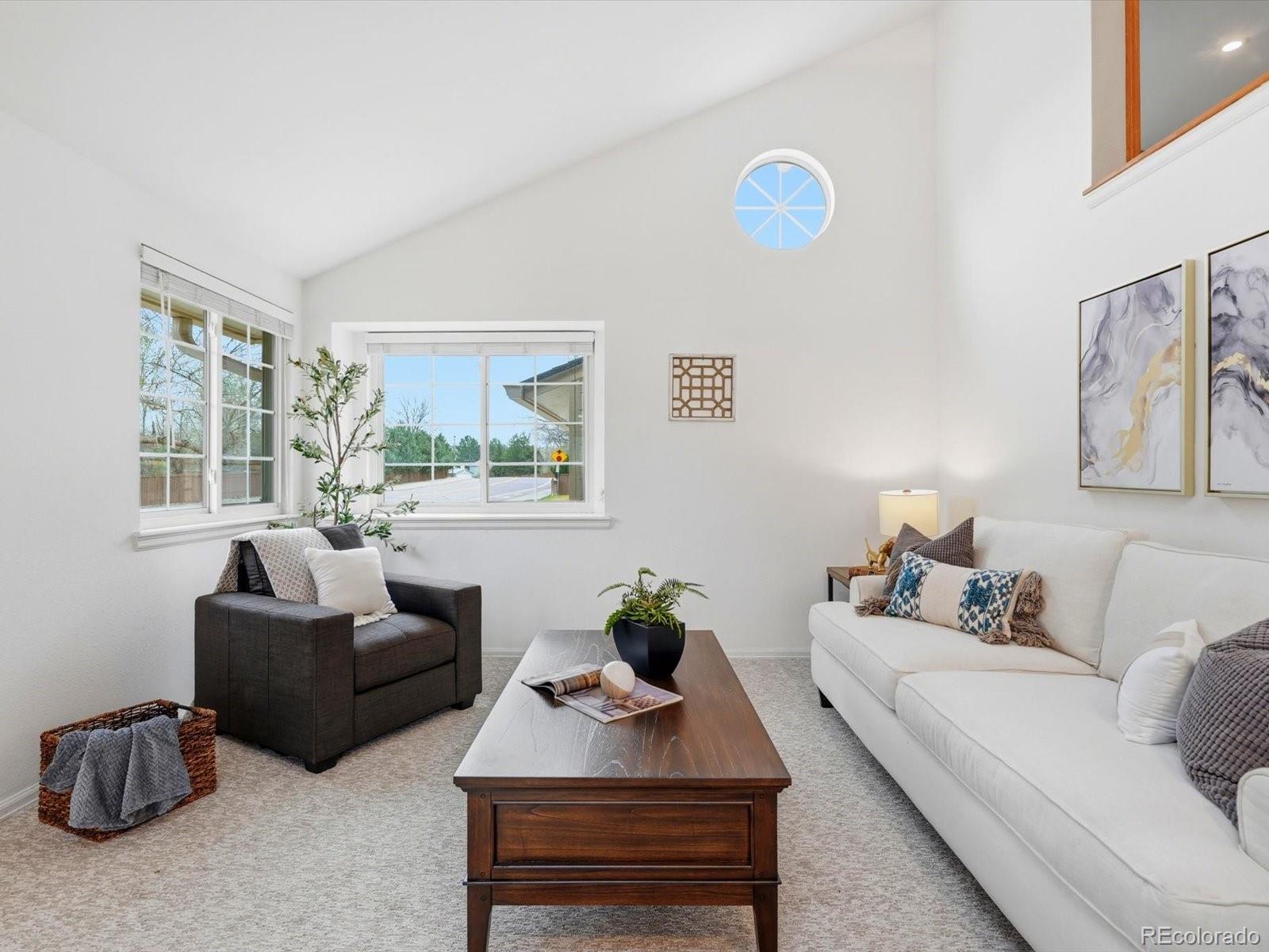 765 Stowe Street Highlands Ranch, CO 80126 - Photo 7 of 43 a living room with furniture a window and a table