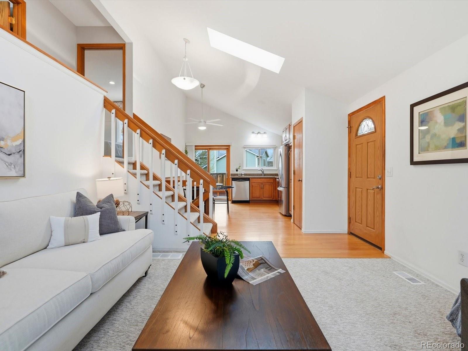 765 Stowe Street Highlands Ranch, CO 80126 - Photo 9 of 43 a living room with furniture and stairs