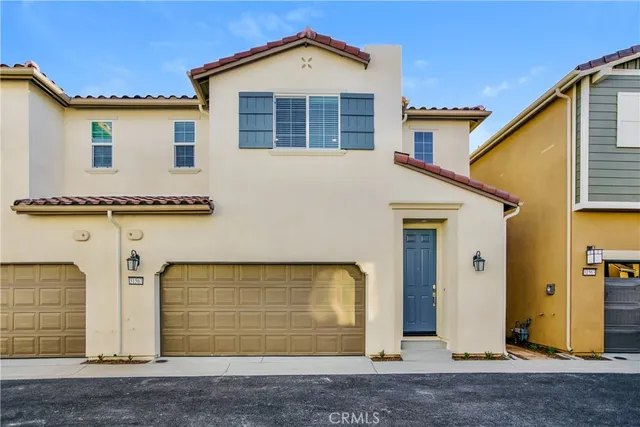 a view of a house with wooden fence