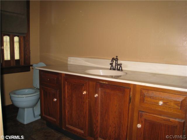 3006 Brookforest Road Midlothian, VA 23112 - Photo 7 of 8 a bathroom with a toilet a sink and mirror