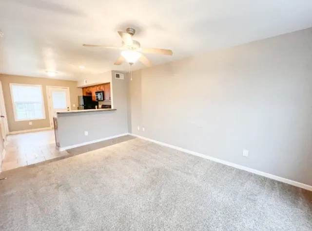 a view of a kitchen with a sink and a refrigerator