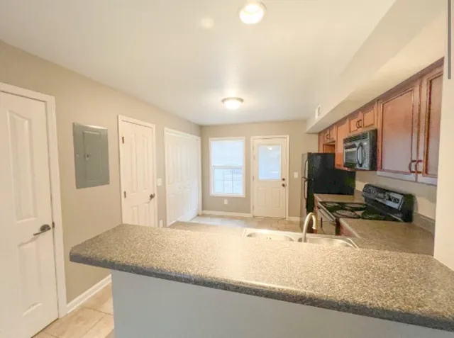 a view of a living room hardwood floor and a large window