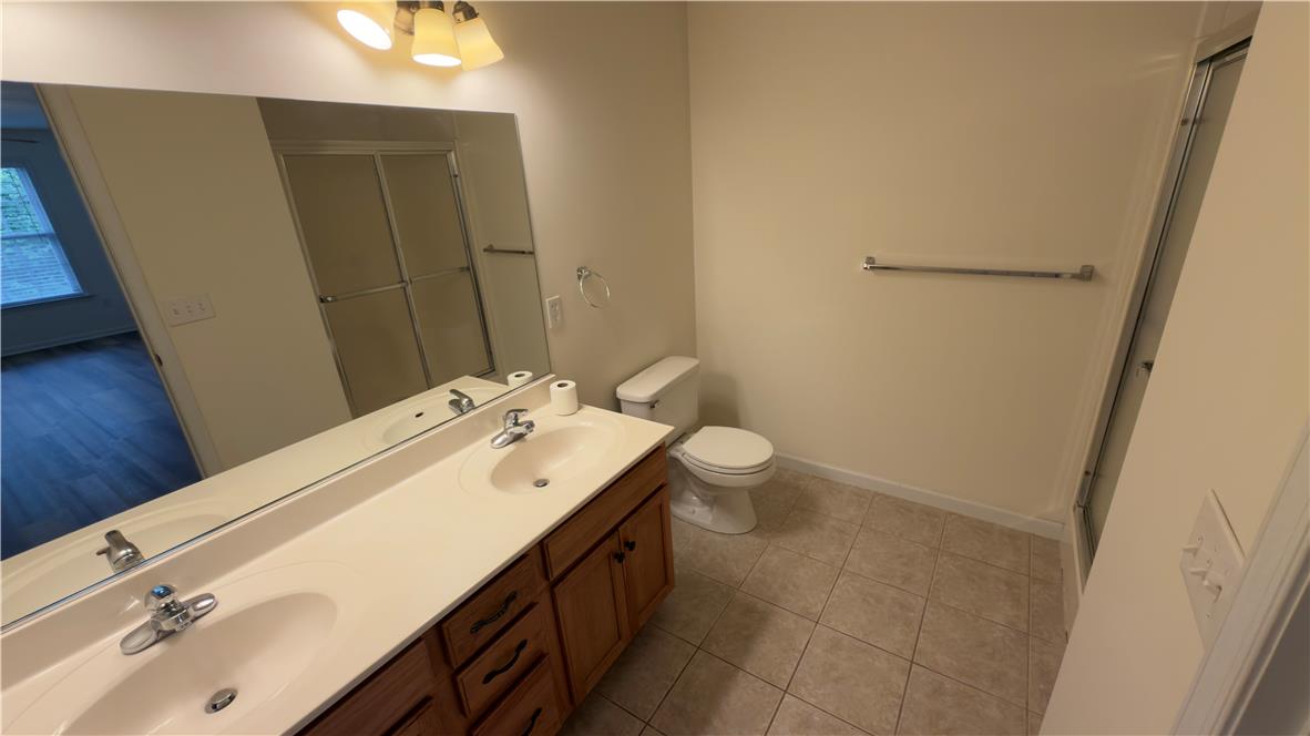 4172 Ross Road Bethlehem, PA 18020 - Photo 11 of 16 Double vanity sinks and tiled flooring define this classic bathroom space.