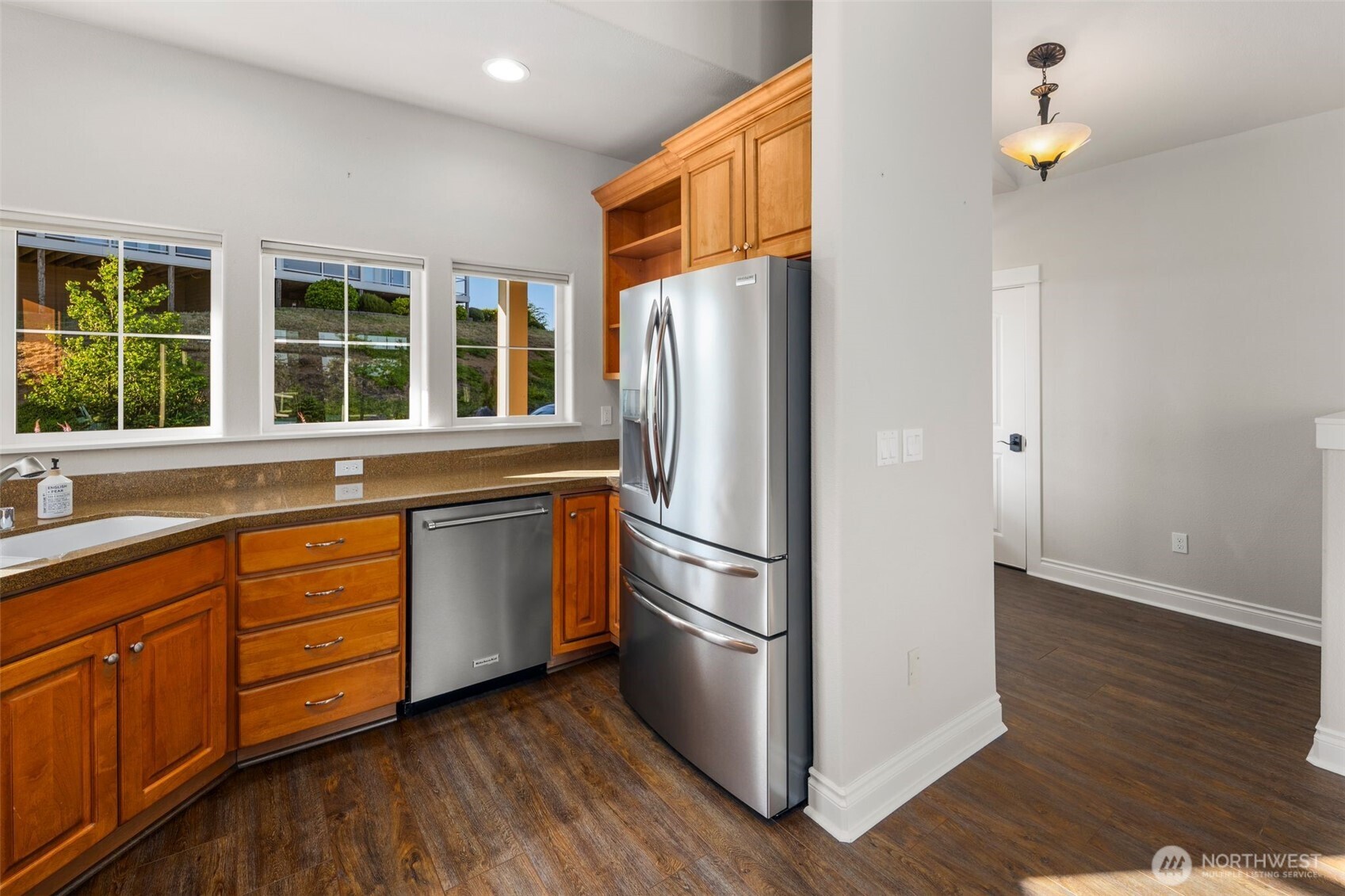 3224 Overlook Loop Ilwaco, WA 98624 - Photo 8 of 38 a kitchen with stainless steel appliances granite countertop a refrigerator a stove a sink and dishwasher with wooden floor